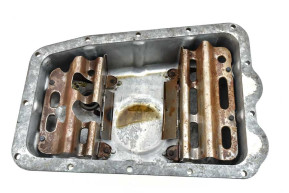 Oil pan with plug and partitions