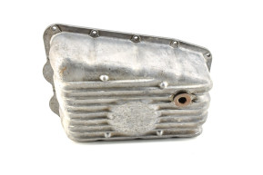 Oil pan with plug and partitions