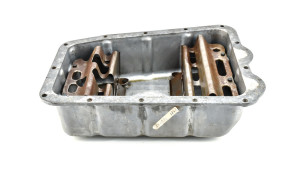 Oil pan with plug and partitions